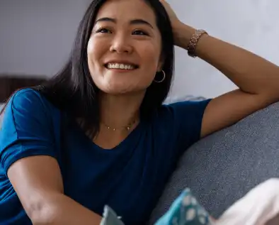 Smiling woman celebrating her debt-free status.